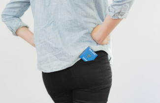 Nainen takataskussaan kondomi.