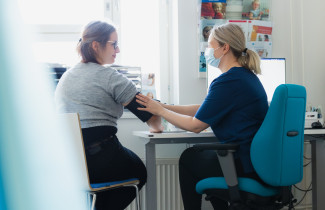 Asiakas ja ammattilainen vastaanotolla.