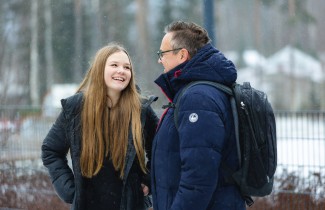 Nuori ja aikuinen ulkoilevat talvisäässä.