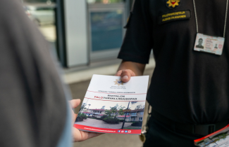 Palotarkastaja ojentaa itsearviointiopasta 