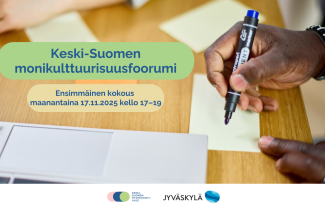 Käsi kirjoittamassa muistilapulle. Teksti: 'Keski-Suomen monikulttuurisuusfoorumi. Ensimmäinen kokous maanantaina 17.11.2025 kello 17-19.'