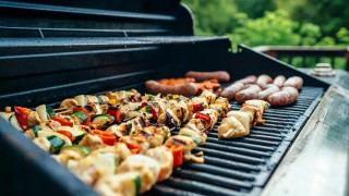 Kuuma grilli jossa kasviksia ja makkaroita